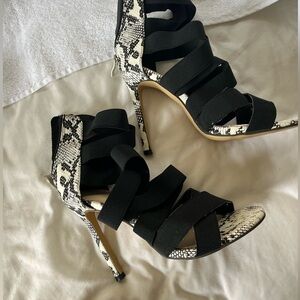 Snake heels black strappy criss- cross design.  The black straps are stretchy!